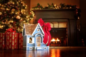 mini-dollhouse-with-red-ribbon-under-christmas-tree